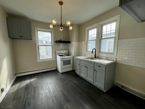 a kitchen with a sink window and cabinets
