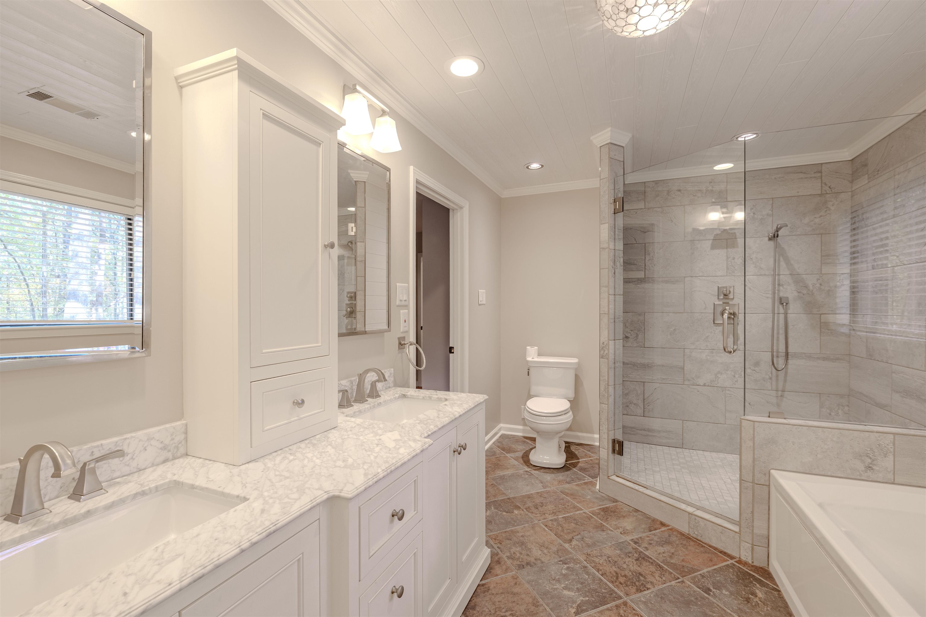 4808 Oak Road Bartlett, TN 38002 - Photo 12 of 35 Primary renovated bathroom with a garden tub, double vanity, a stall shower, crown molding, and recessed lighting