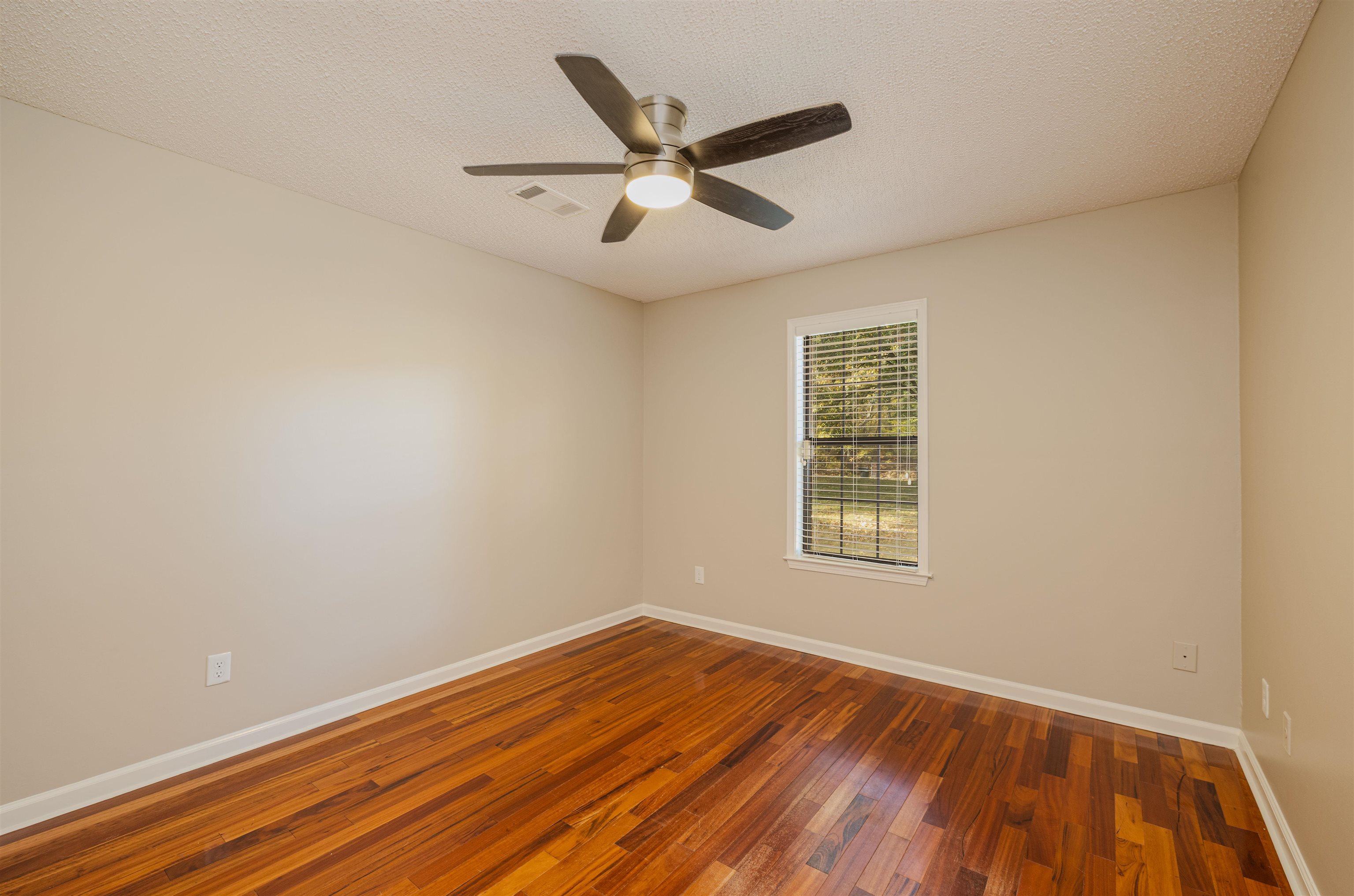 4808 Oak Road Bartlett, TN 38002 - Photo 16 of 35 Bedroom 3 downstairs featuring wood-type flooring, a textured ceiling, and ceiling fan