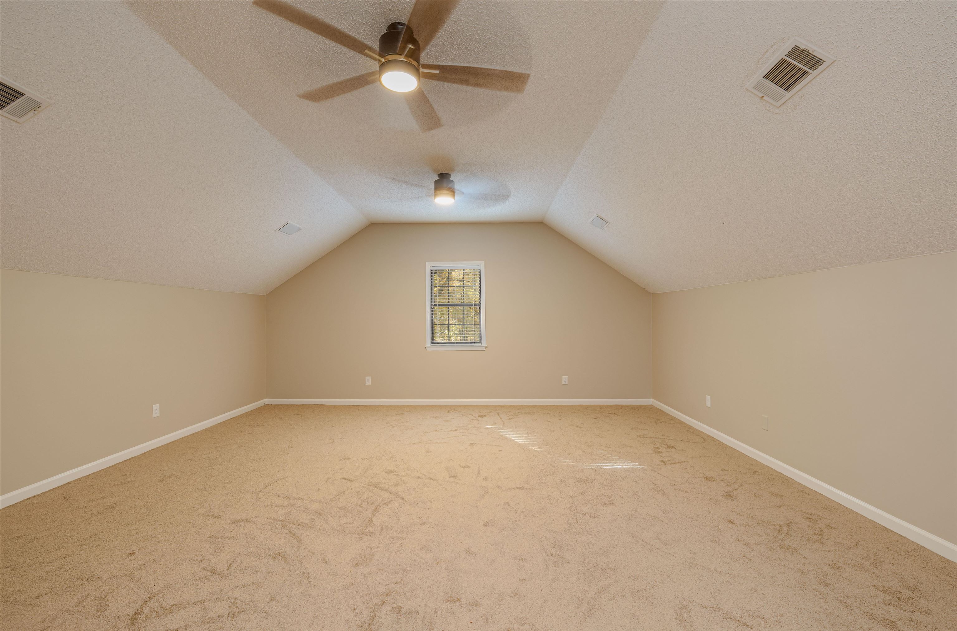 4808 Oak Road Bartlett, TN 38002 - Photo 19 of 35 Bedroom 4 / Bonus Room featuring lofted ceiling, carpet floors, ceiling fan, and a textured ceiling