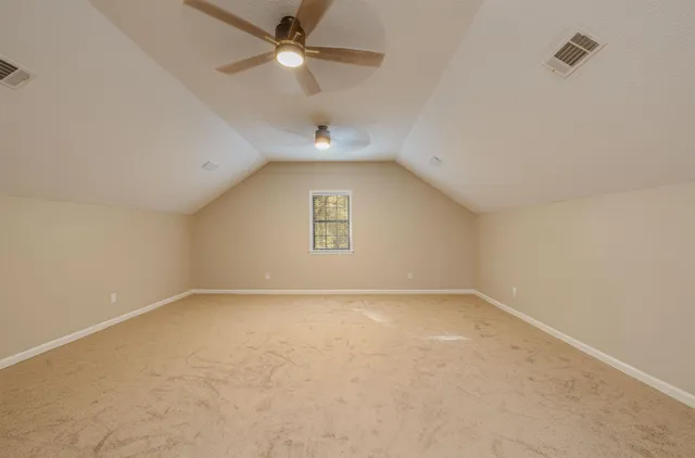 an empty room with a ceiling fan and a ceiling fan