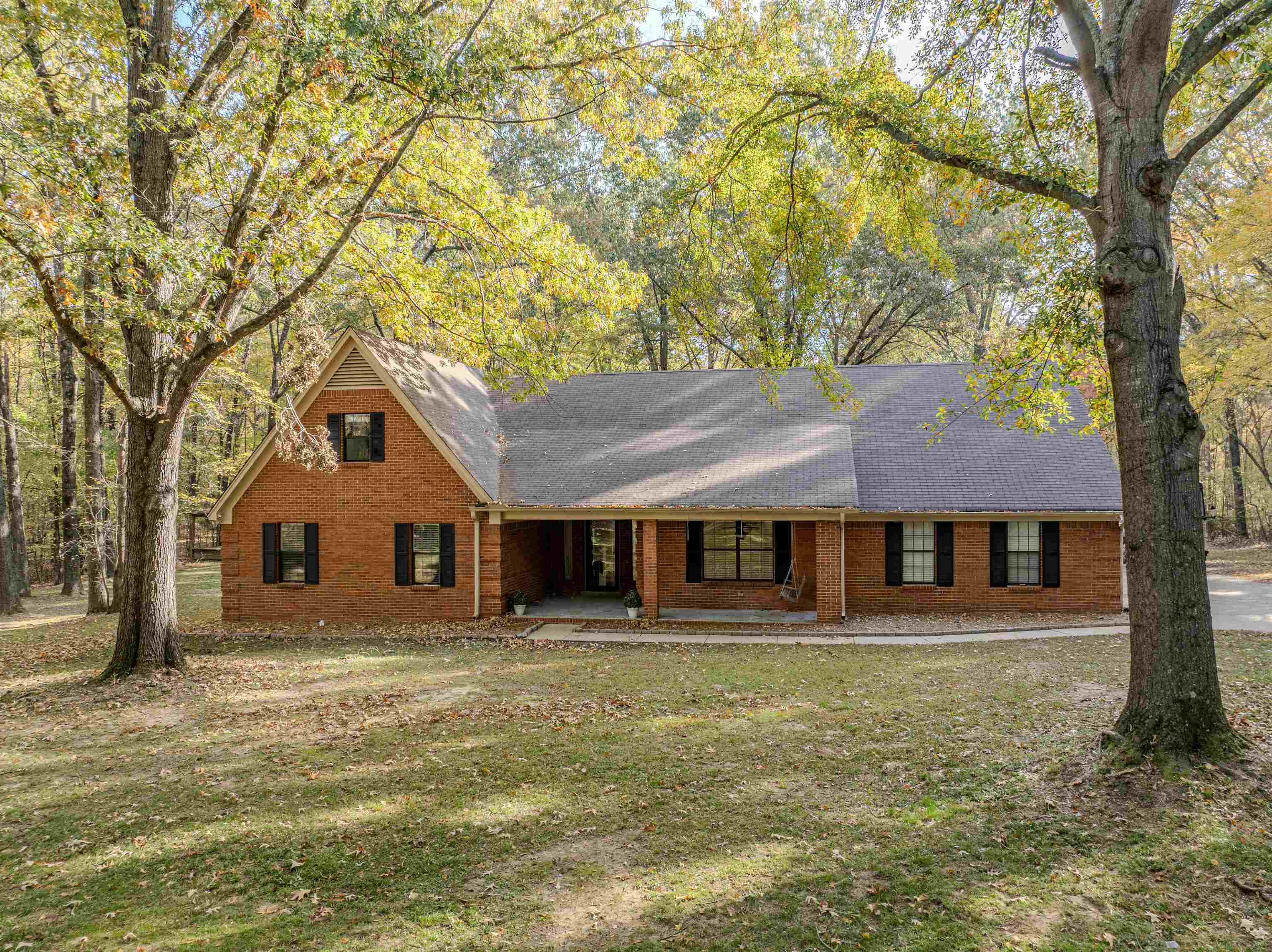 4808 Oak Road Bartlett, TN 38002 - Photo 24 of 35 View of front of property featuring a front yard, a porch, brick siding, and a shingled roof