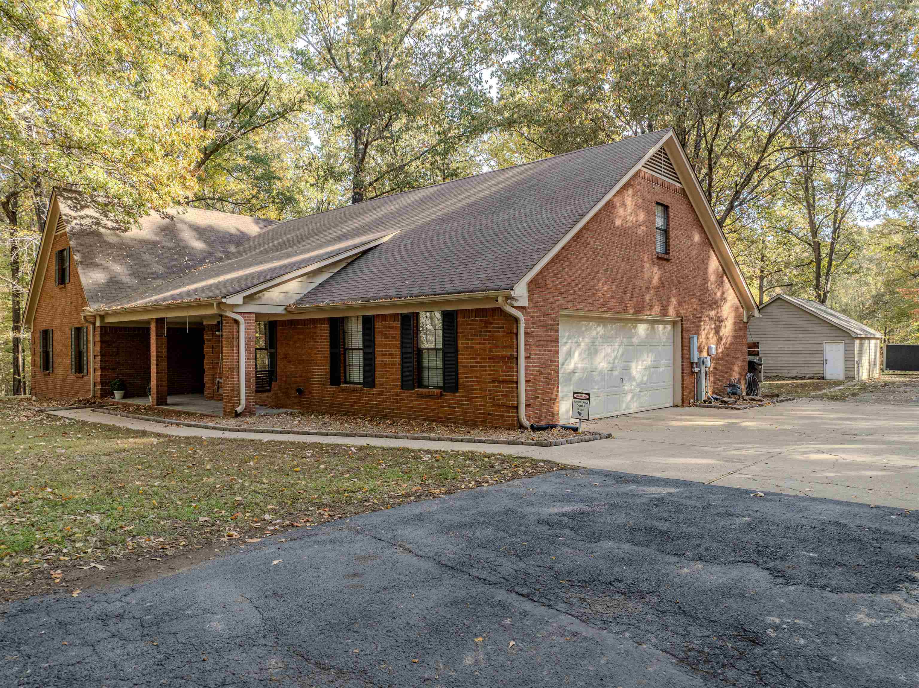 4808 Oak Road Bartlett, TN 38002 - Photo 30 of 35 View of front of house featuring brick siding, roof with shingles, a garage, concrete driveway, and a porch