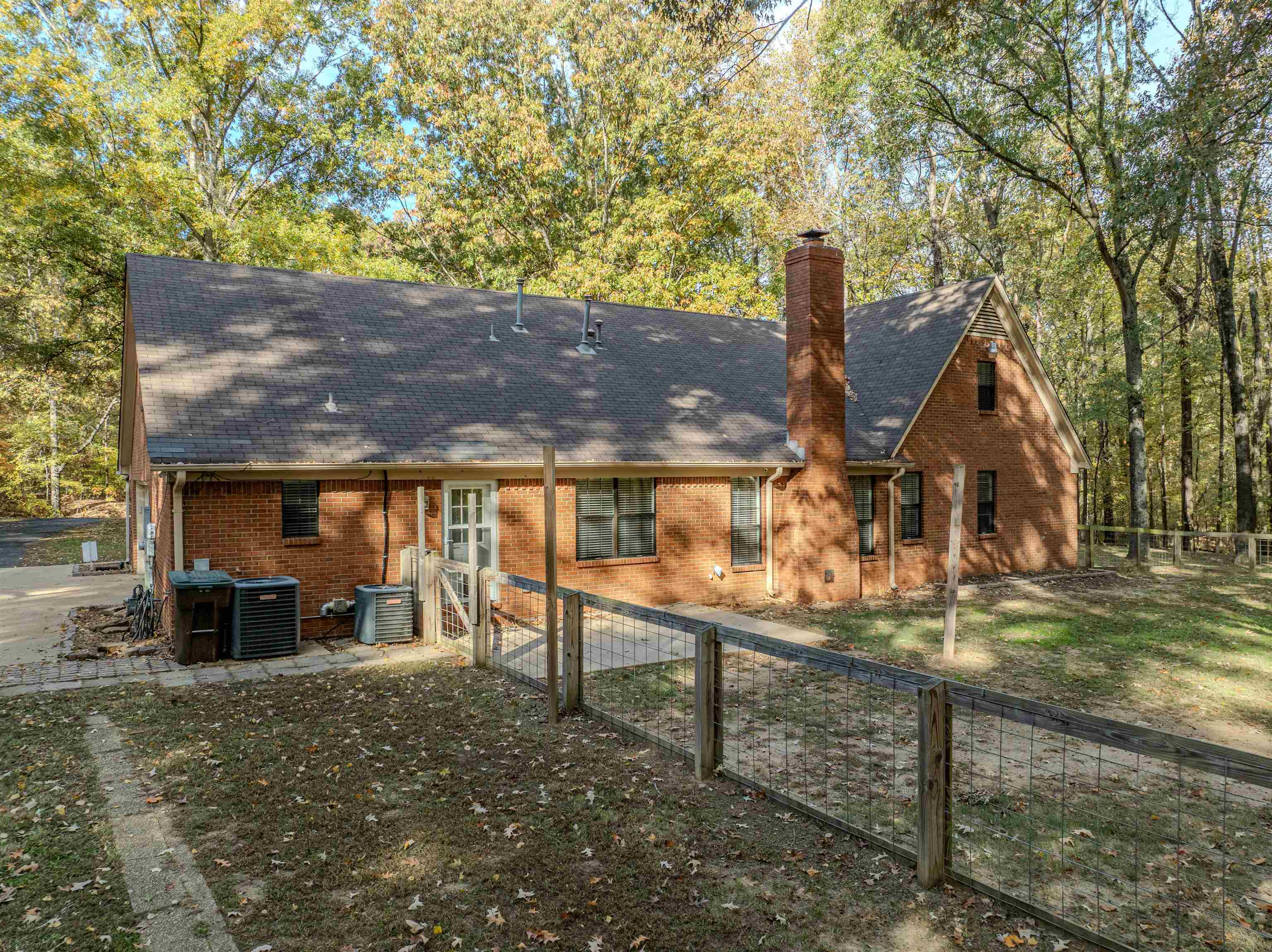 4808 Oak Road Bartlett, TN 38002 - Photo 31 of 35 Back of property with a shingled roof, a fenced backyard, a chimney, and brick siding