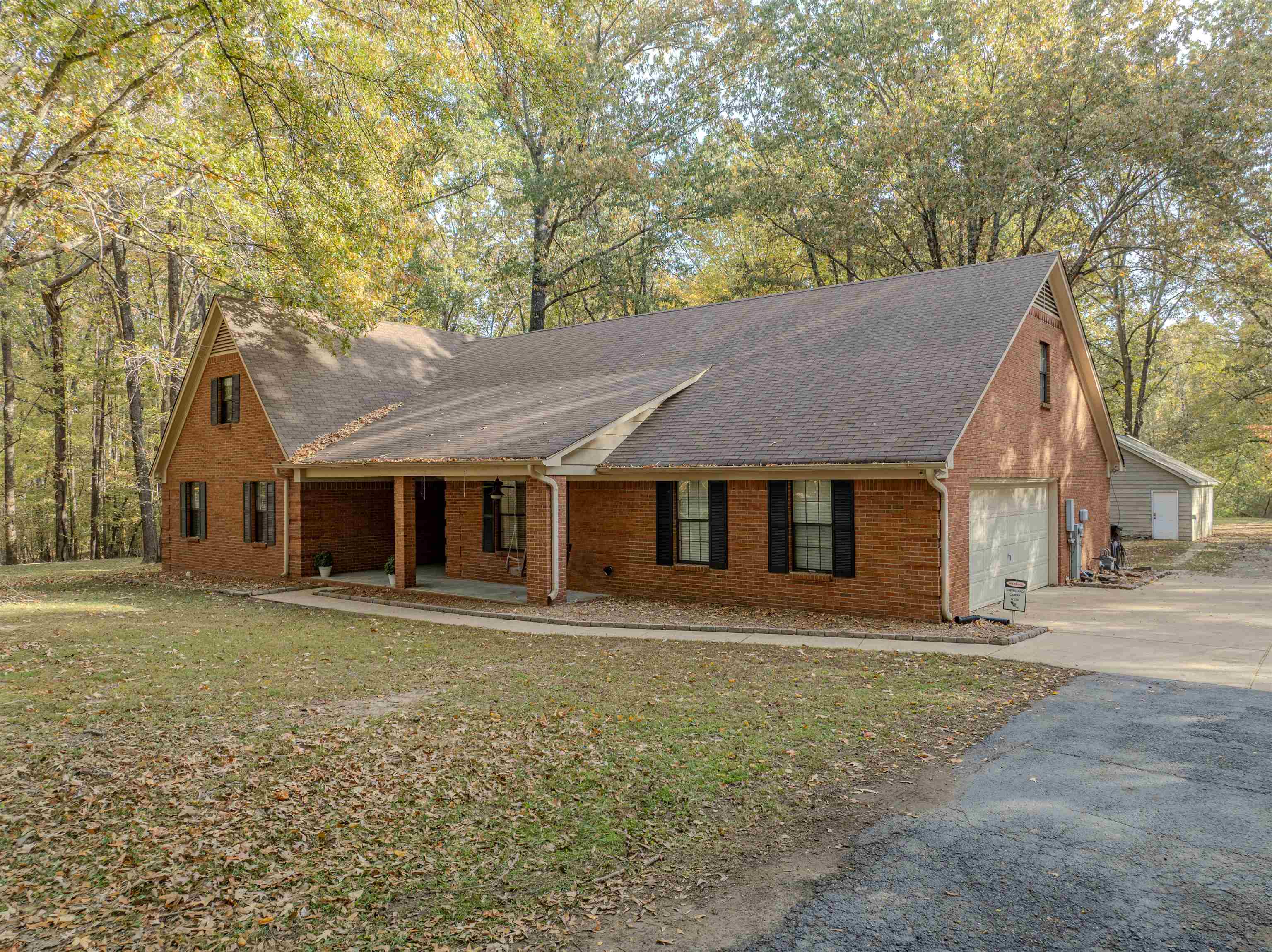 4808 Oak Road Bartlett, TN 38002 - Photo 32 of 35 View of front of property with a garage, brick siding, covered porch, a shingled roof, and driveway