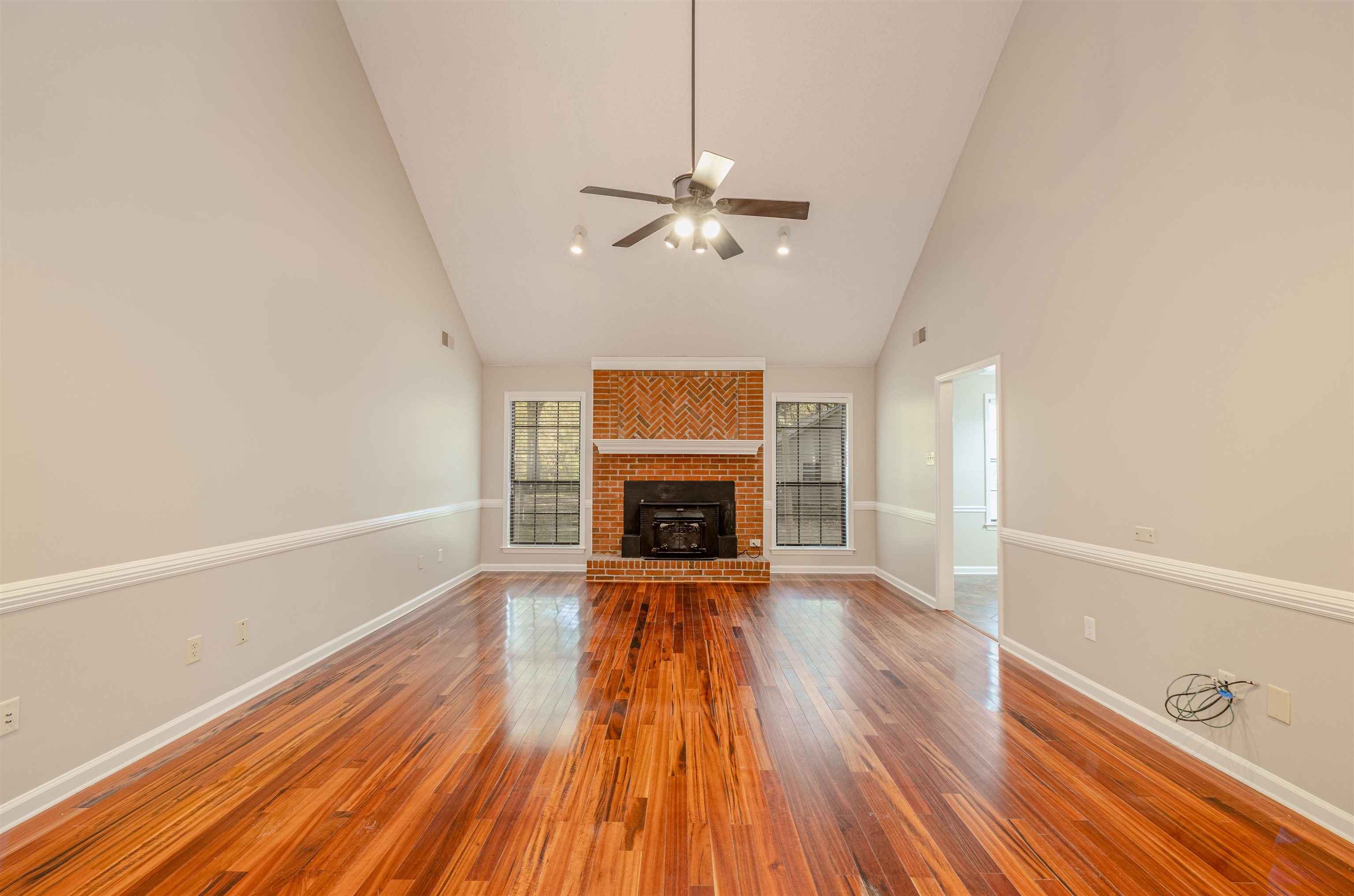 4808 Oak Road Bartlett, TN 38002 - Photo 4 of 35 Unfurnished living room featuring high vaulted ceiling, wood finished floors, and ceiling fan