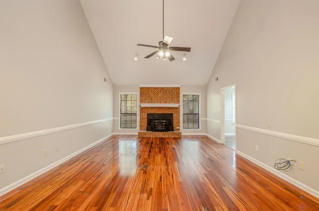 wooden floor in an empty room with a fireplace