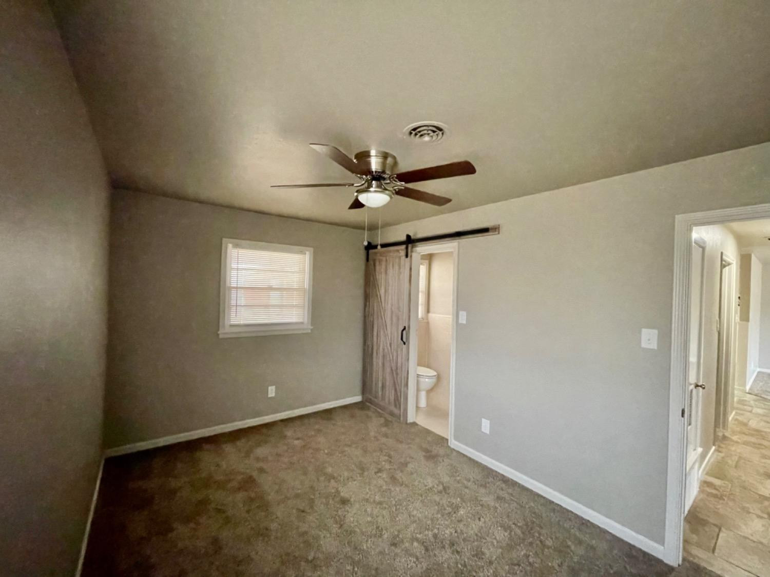 1201 Adrian Street Lubbock, TX 79403 - Photo 11 of 19 a view of a livingroom with a ceiling fan and window
