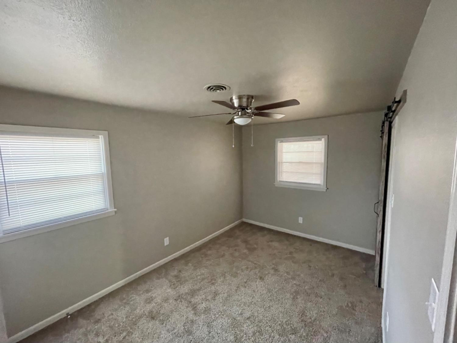 1201 Adrian Street Lubbock, TX 79403 - Photo 12 of 19 an empty room with a window