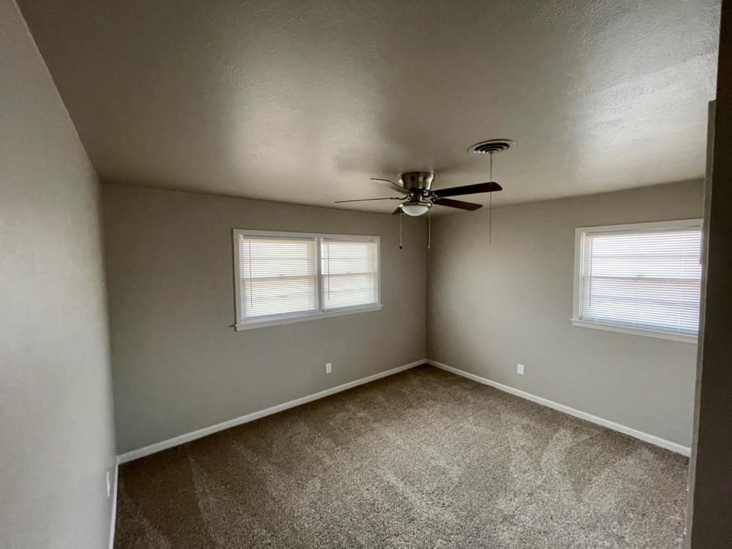 1201 Adrian Street Lubbock, TX 79403 - Photo 15 of 19 an empty room with windows