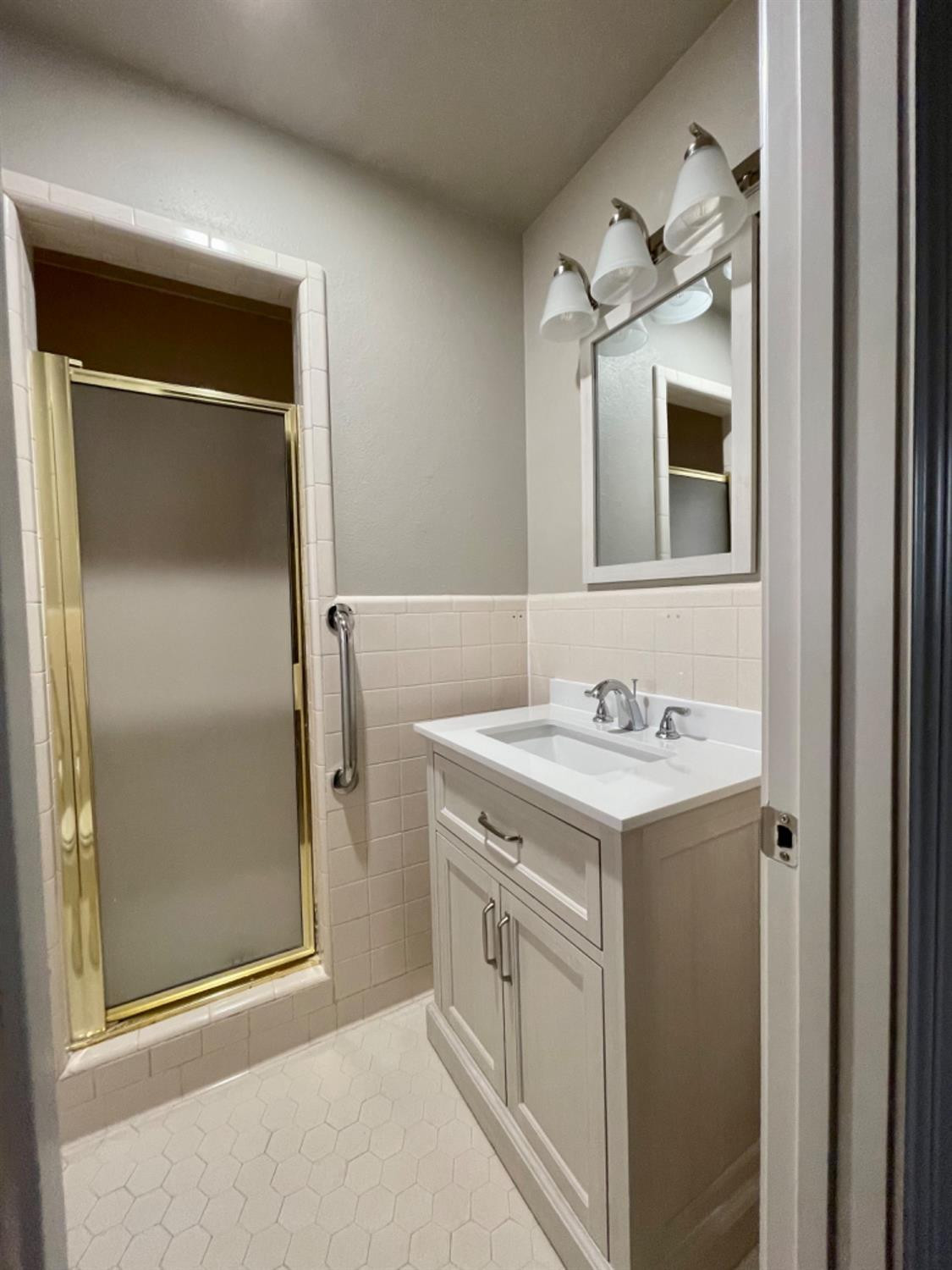 1201 Adrian Street Lubbock, TX 79403 - Photo 17 of 19 a bathroom with a granite countertop sink and mirror