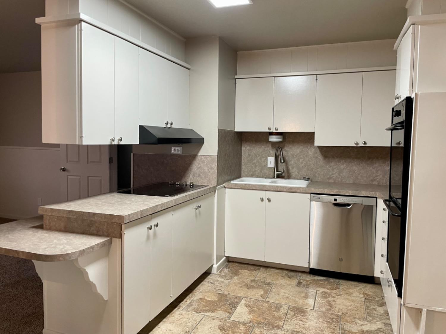 1201 Adrian Street Lubbock, TX 79403 - Photo 5 of 19 a kitchen with a sink stove and refrigerator