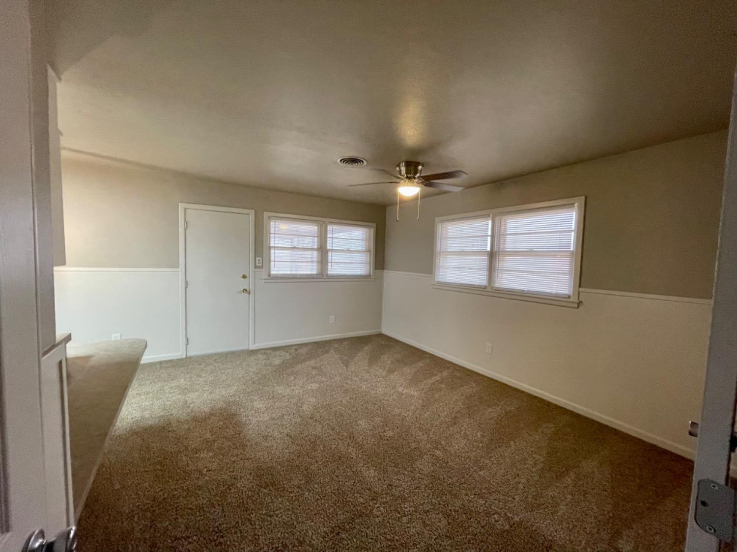 1201 Adrian Street Lubbock, TX 79403 - Photo 9 of 19 a view of an empty room with a window
