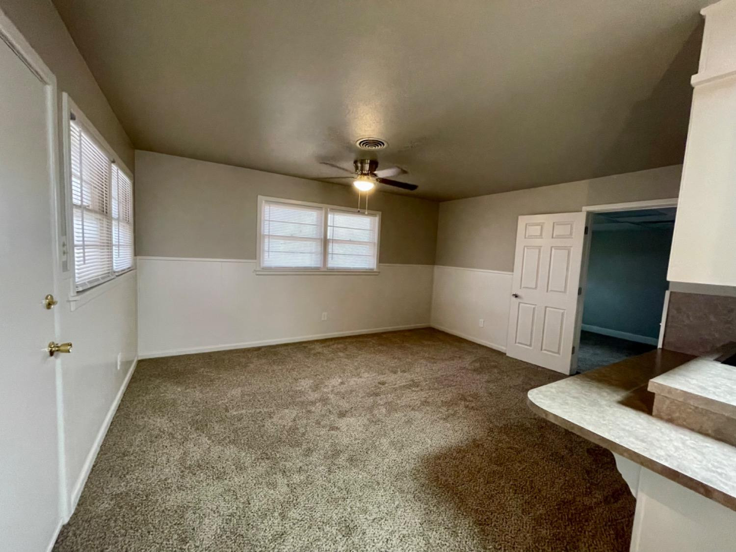 1201 Adrian Street Lubbock, TX 79403 - Photo 10 of 19 a view of an empty room with a window