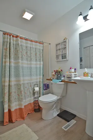 a bathroom with a sink toilet and shower