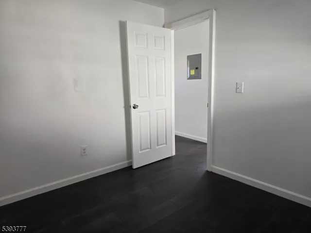 an empty room with wooden floor and closet