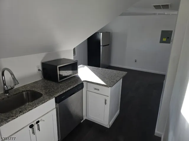 a kitchen with a sink and cabinets