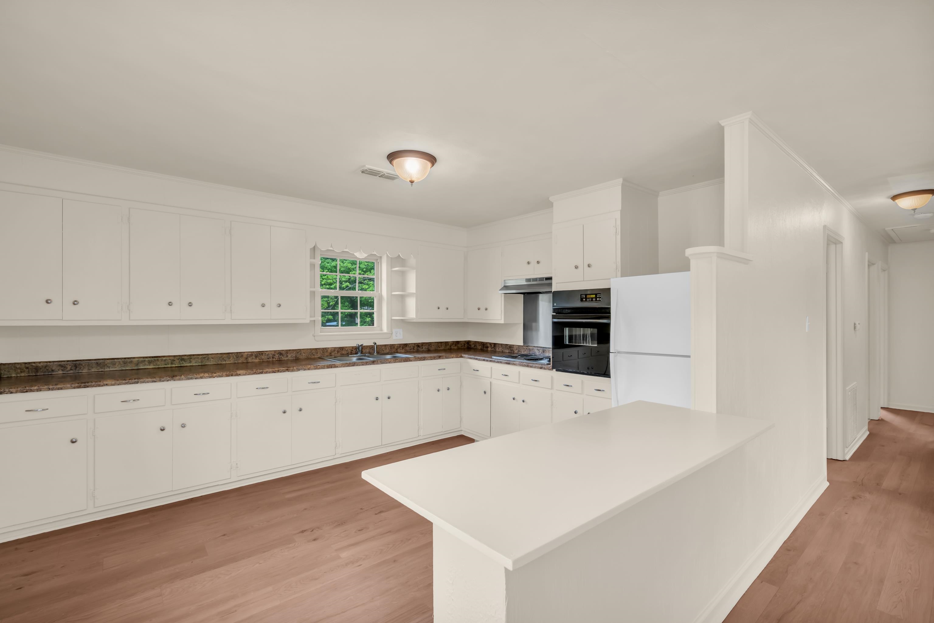 400 Coffee Shop Road Ripley, TN 38063 - Photo 5 of 23 a kitchen with granite countertop white cabinets and white appliances