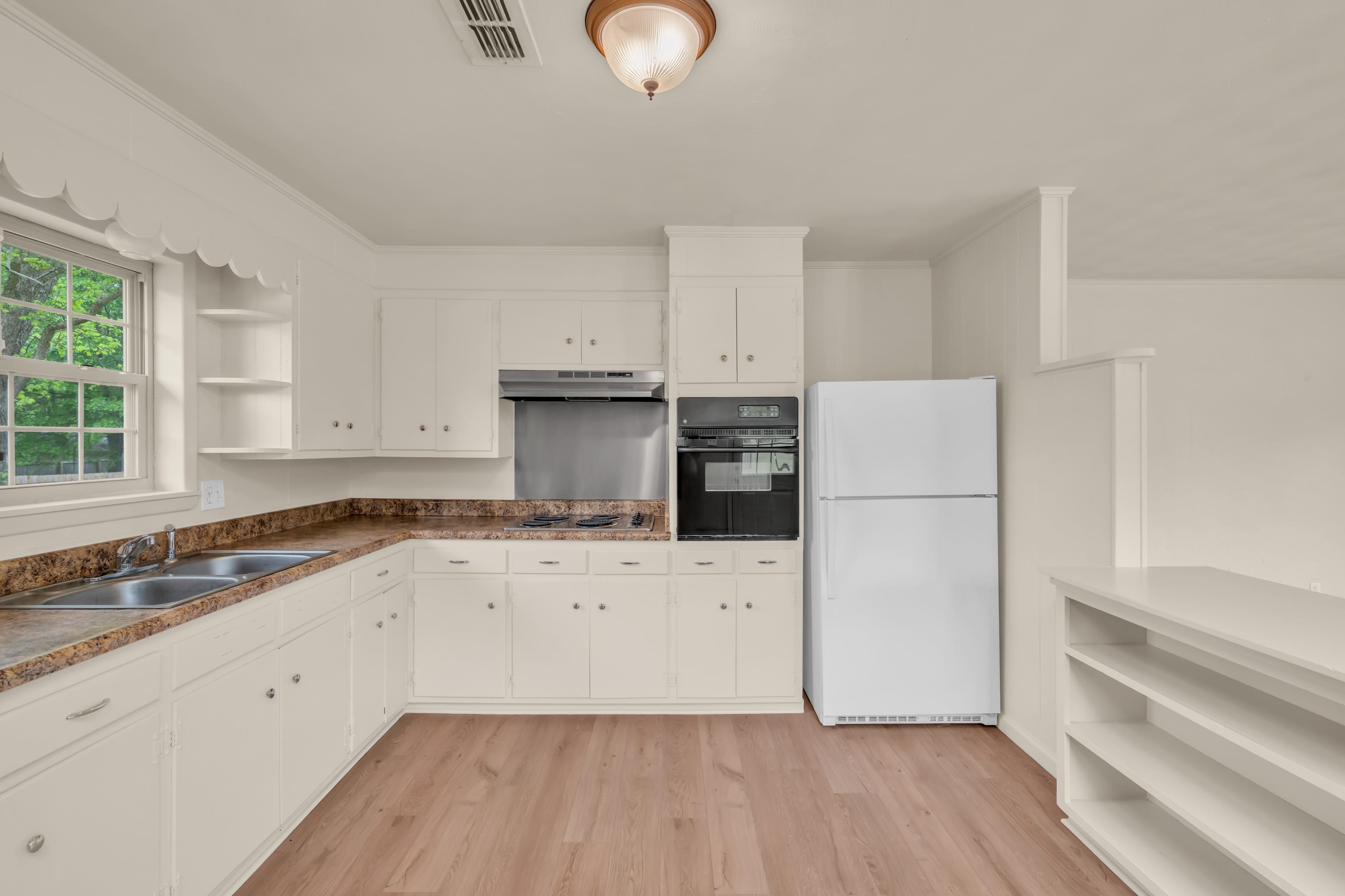 400 Coffee Shop Road Ripley, TN 38063 - Photo 6 of 23 a kitchen with granite countertop white cabinets and white appliances