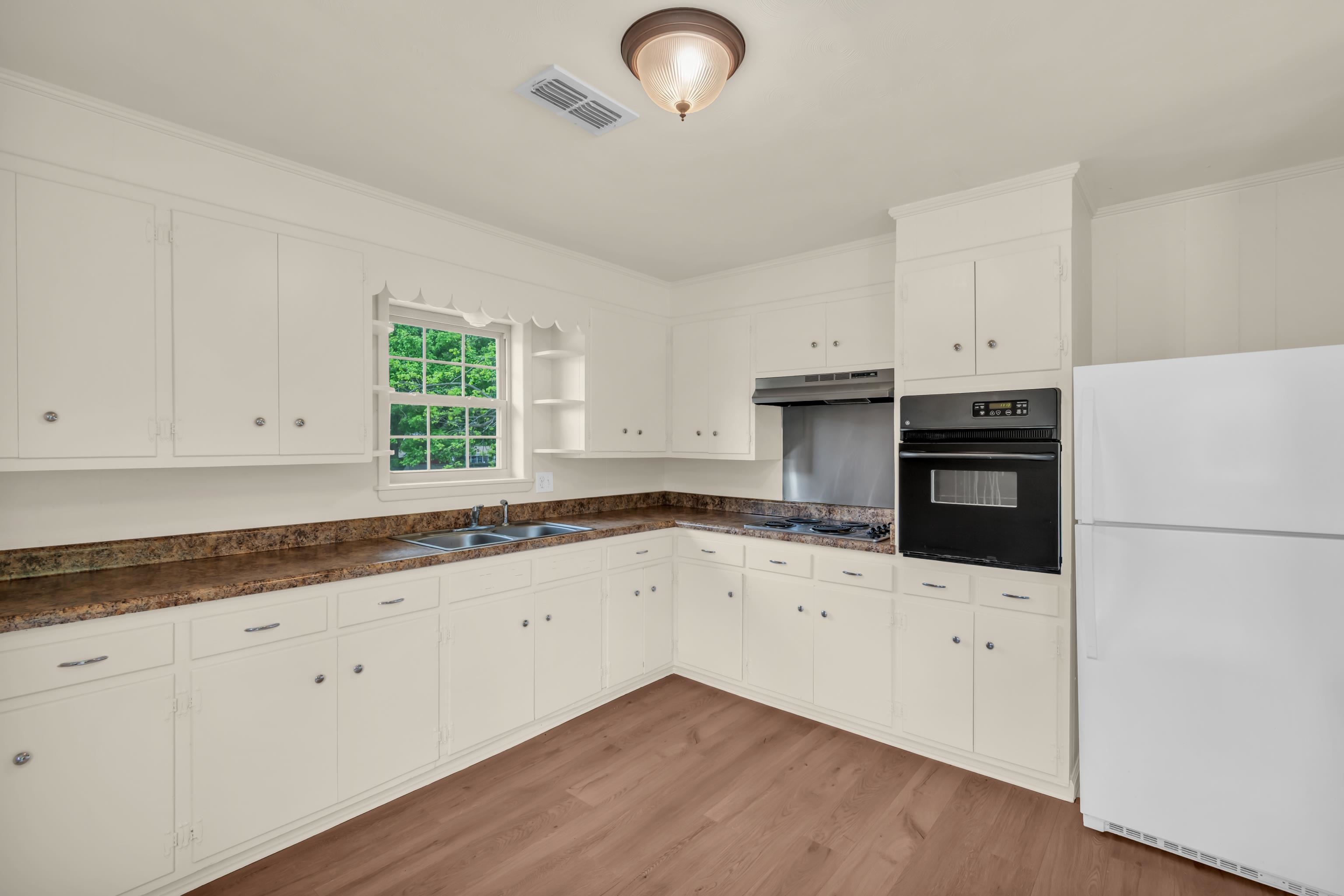 400 Coffee Shop Road Ripley, TN 38063 - Photo 7 of 23 a kitchen with granite countertop white cabinets and white appliances