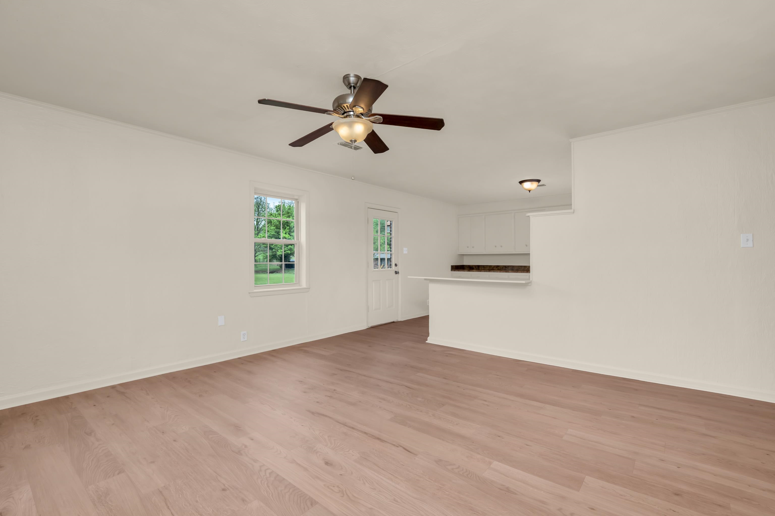 400 Coffee Shop Road Ripley, TN 38063 - Photo 9 of 23 an empty room with wooden floor and windows