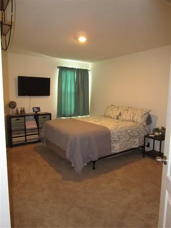 a bedroom with a bed and a television