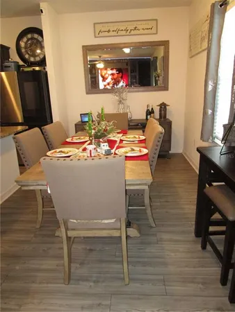 a view of a dining room with furniture and wooden floor