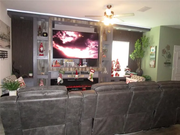 a living room with fireplace furniture and a chandelier