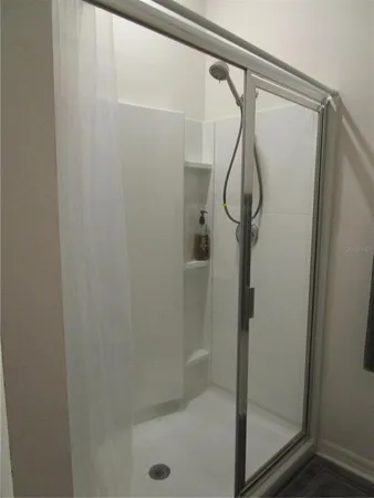 a bathroom with a glass shower door