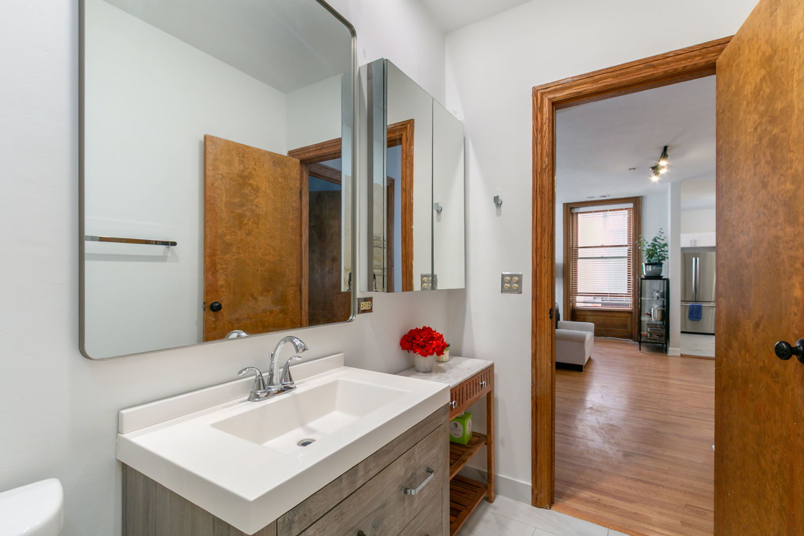 550 West Surf Street, Unit C316 Chicago, IL 60657 - Photo 11 of 16 a bathroom with a sink vanity tub and a mirror