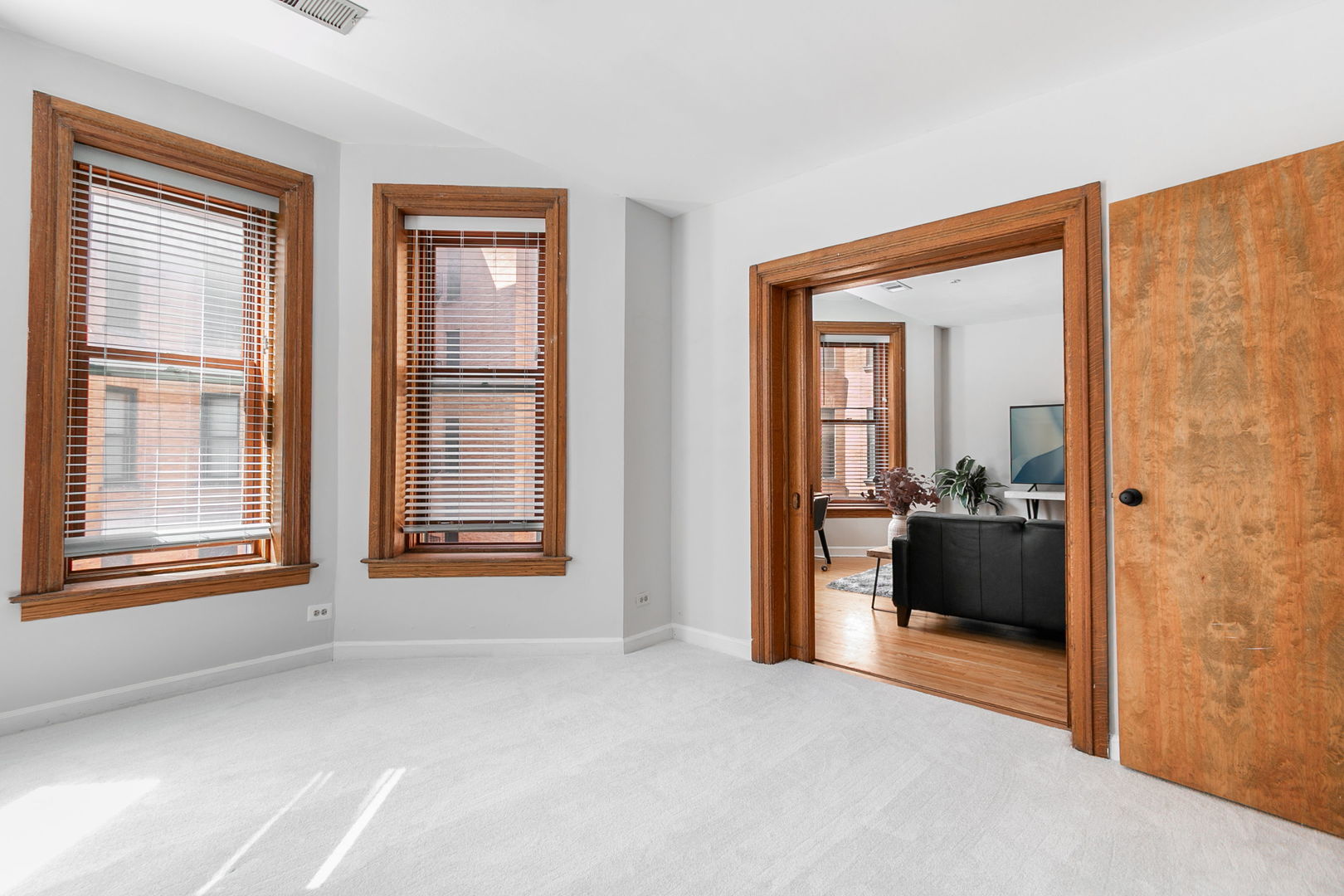 550 West Surf Street, Unit C316 Chicago, IL 60657 - Photo 14 of 16 a view of a bedroom with a large bed and two large window