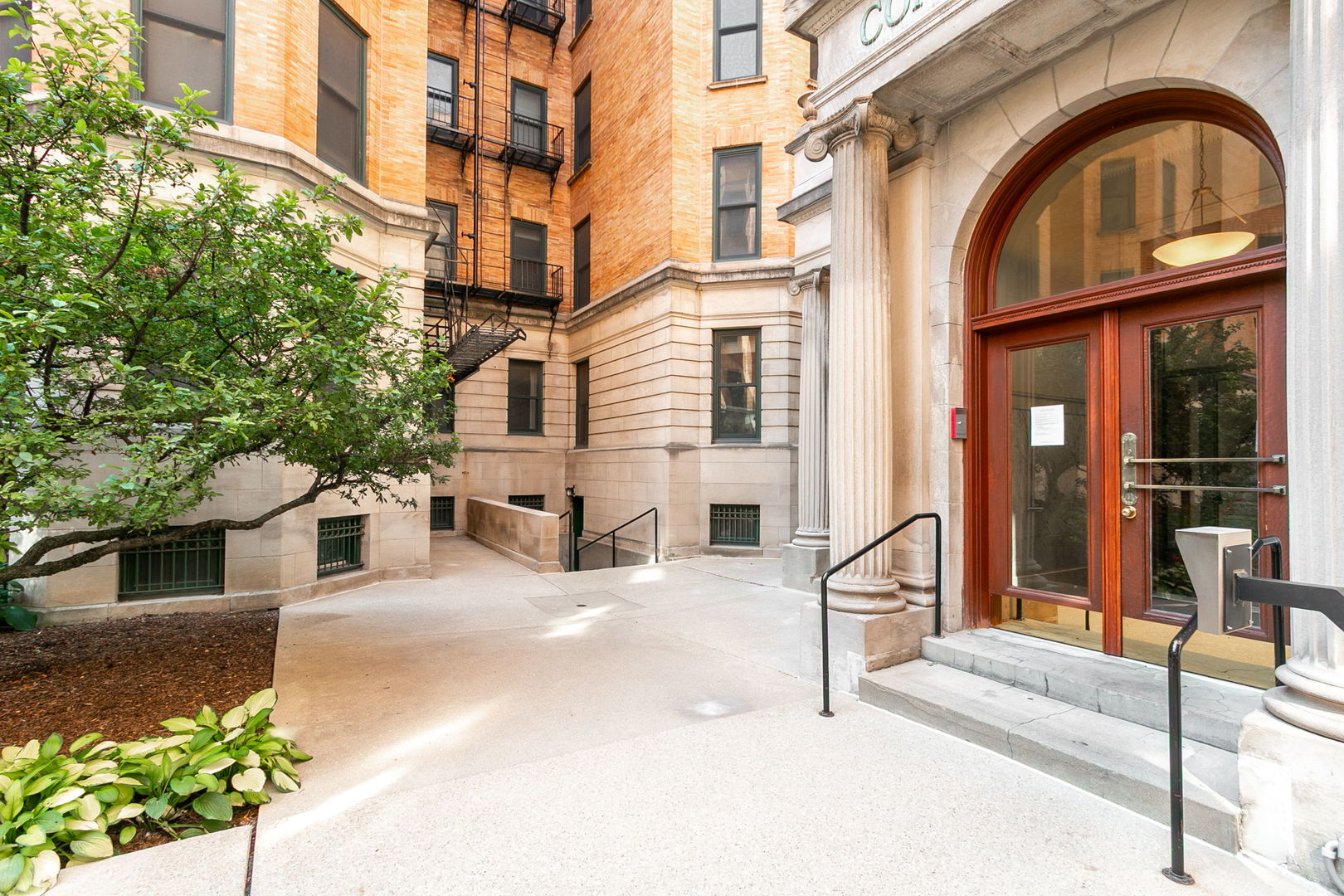 550 West Surf Street, Unit C316 Chicago, IL 60657 - Photo 2 of 16 a building with glass door and glass door