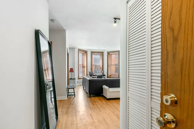 a living room with furniture and a flat screen tv with wooden floor