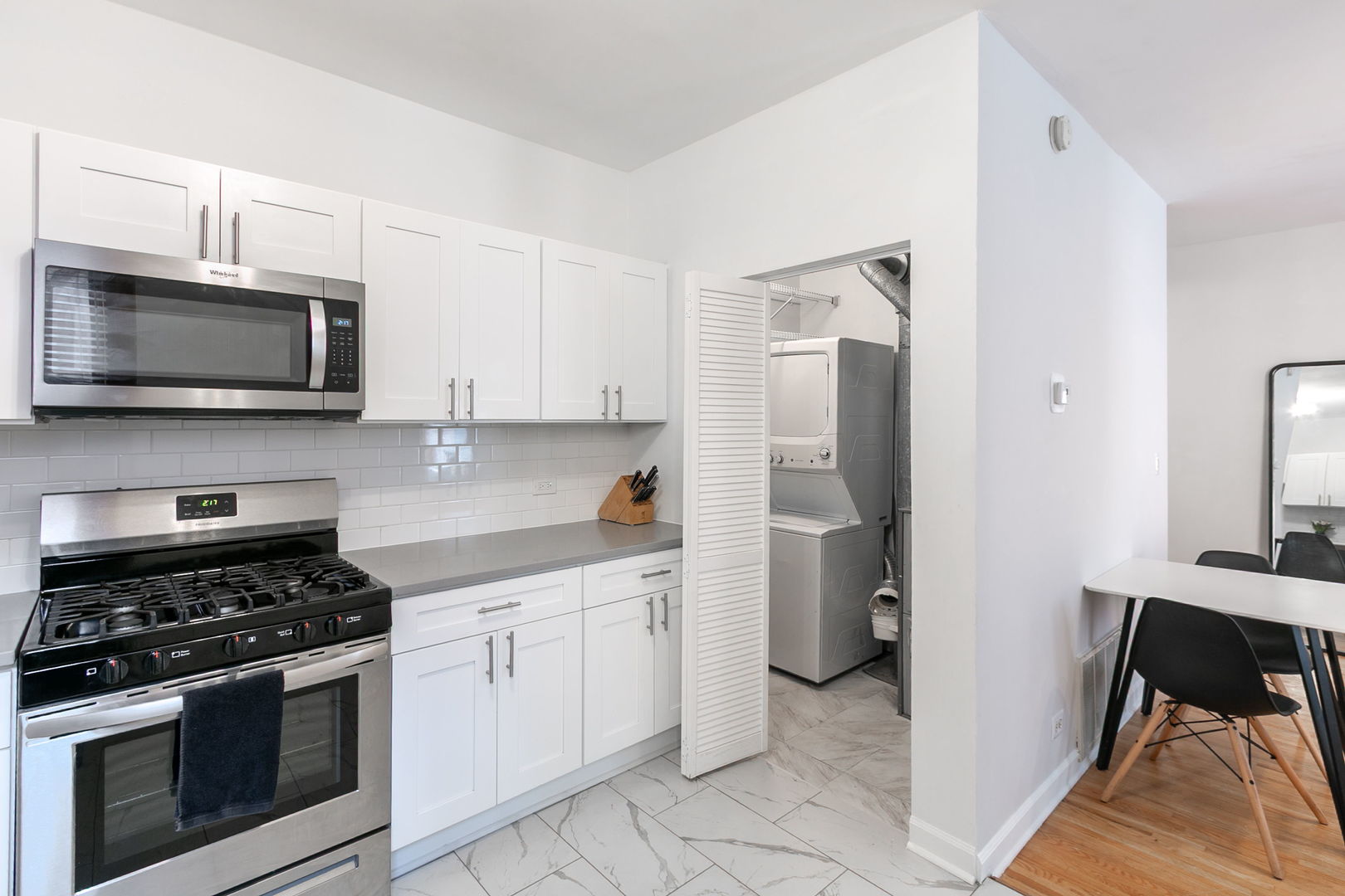 550 West Surf Street, Unit C316 Chicago, IL 60657 - Photo 9 of 16 a kitchen with a stove and a microwave