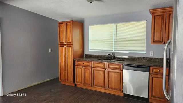an empty room with wooden floor and a window