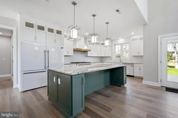 a kitchen with a sink dishwasher a stove and a wooden floors