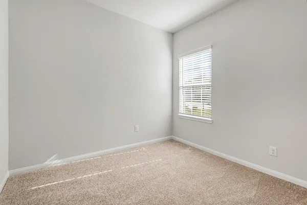 a view of an empty room and closet area