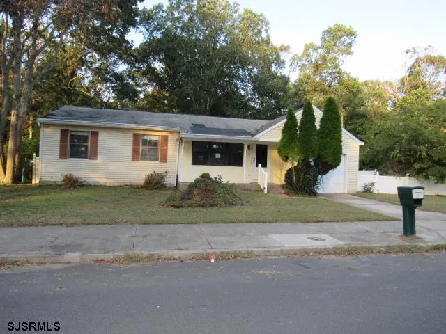 a view of a house with a backyard