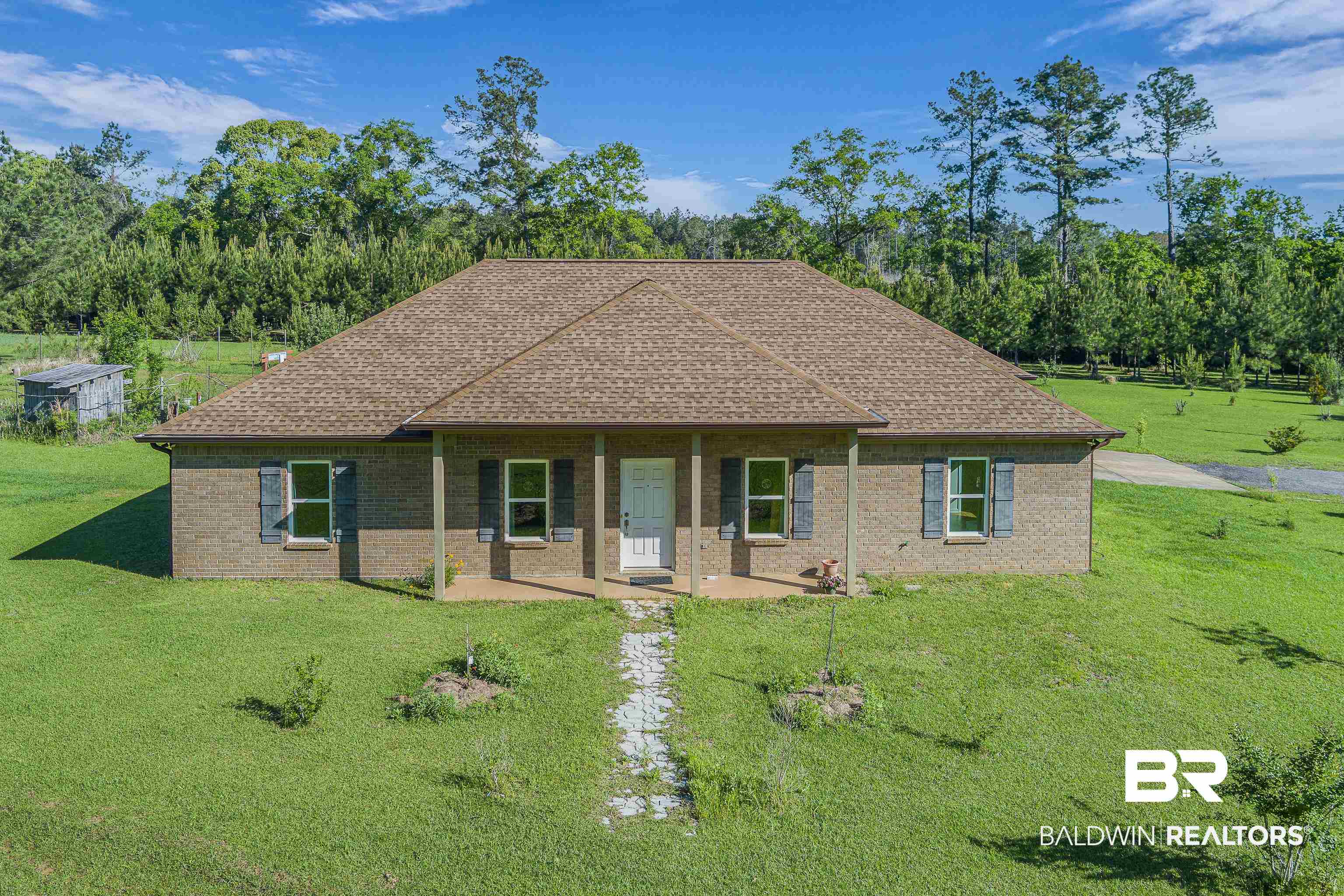 18255 Cactus Court Elberta, AL 36530 - Photo 36 of 53 View of front facade with covered porch, brick siding, a front lawn, and roof with shingles