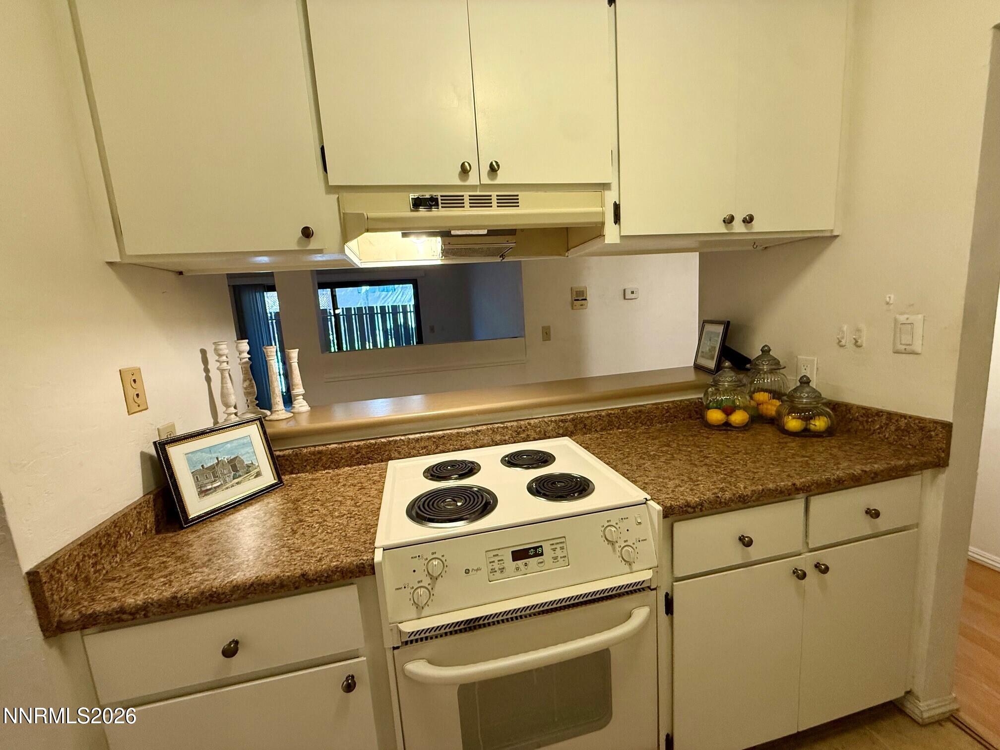 2955 Lakeside Drive, Unit 120 Reno, NV 89509 - Photo 9 of 21 a kitchen with kitchen island granite countertop a sink a stove and cabinets