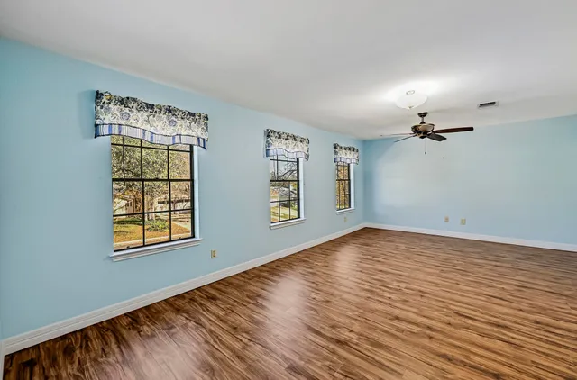 a spacious bathroom with a shower sink and mirror