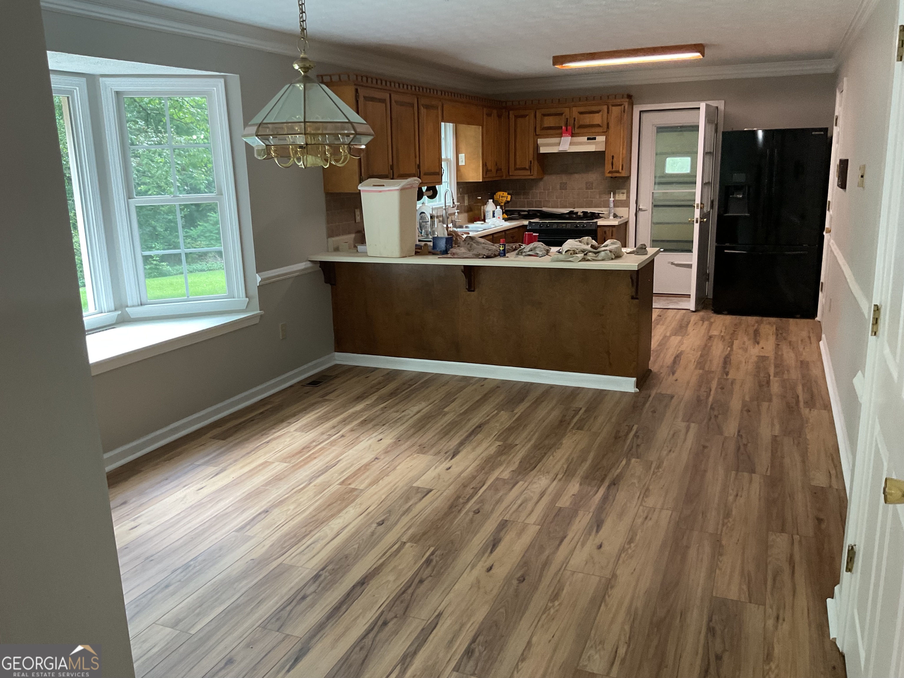 4800 Bethlehem Road Fairburn, GA 30213 - Photo 18 of 49 a view of a kitchen with wooden floor and stainless steel appliances