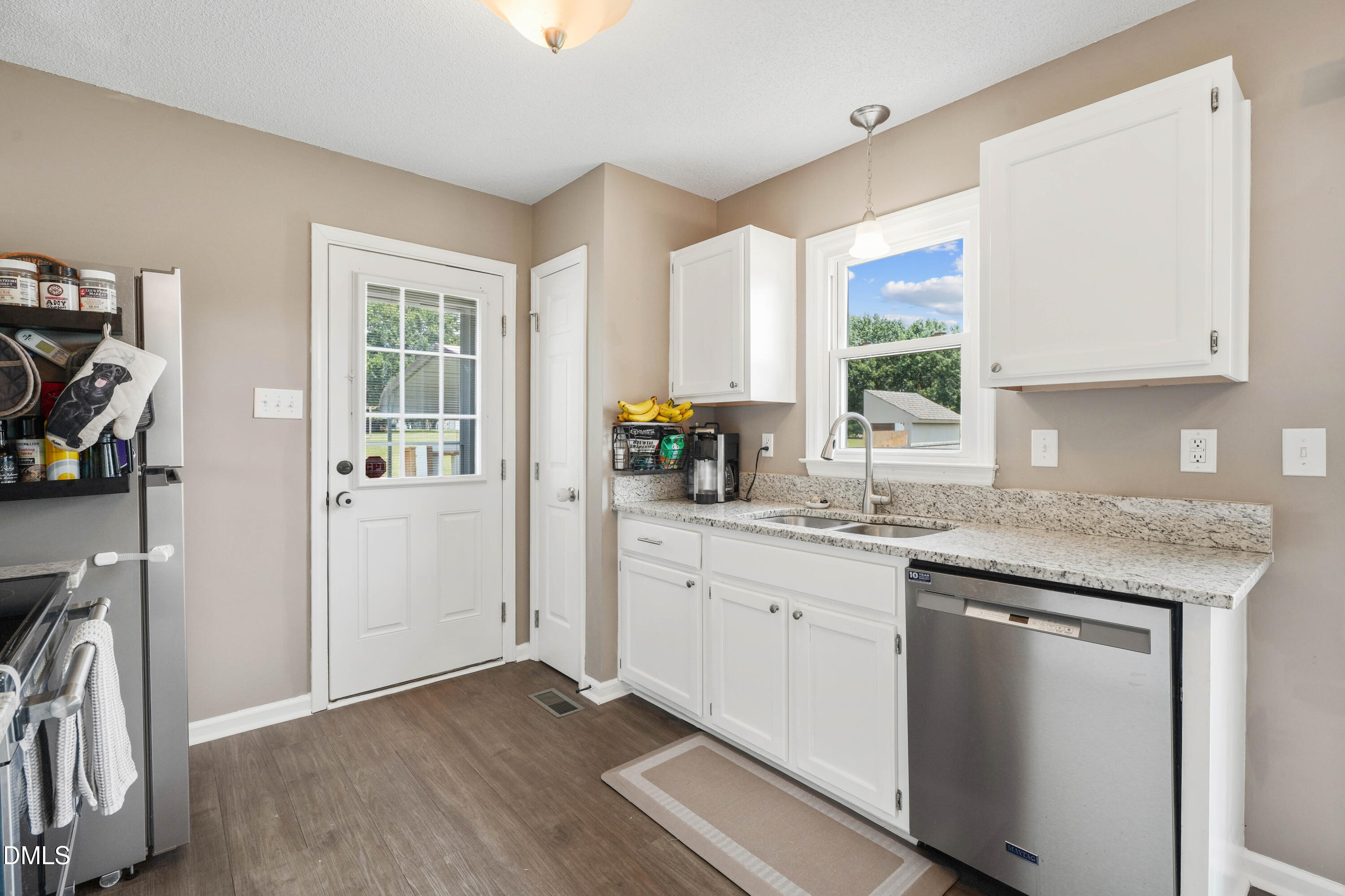 101 Stephenson Road Benson, NC 27504 - Photo 11 of 29 a kitchen with granite countertop cabinets stainless steel appliances a sink and a window