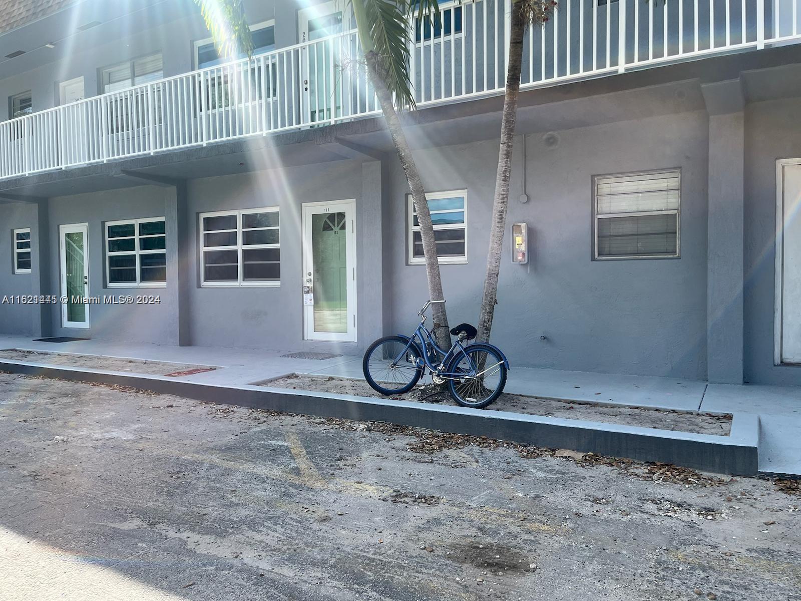 3265 Griffin Road, Unit 104 Dania Beach, FL 33312 - Photo 1 of 14 a view of a house with a yard
