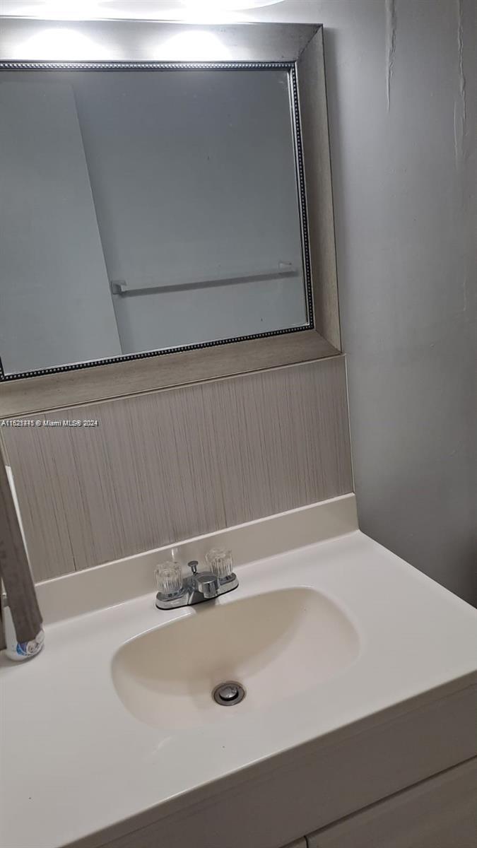 3265 Griffin Road, Unit 104 Dania Beach, FL 33312 - Photo 7 of 14 a bathroom with a sink and vanity