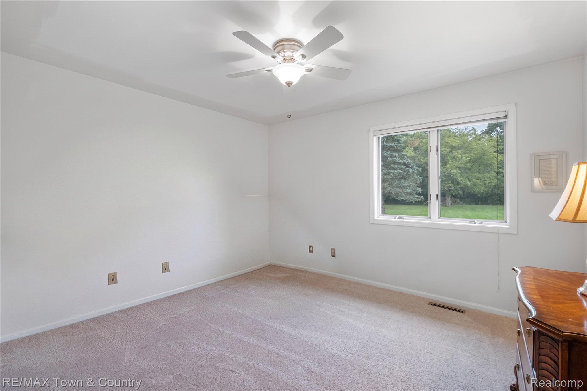 5464 North Seymour Road Flushing, MI 48433 - Photo 20 of 45 Recessed window framing exterior greenery, ceiling fan with integrated lighting, and neutral carpeting