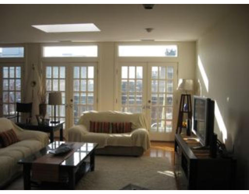 488 Beacon Street, Unit 18 Boston, MA 02115 - Photo 2 of 5 a living room with furniture and a floor to ceiling window