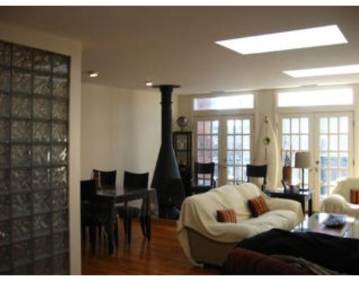 488 Beacon Street, Unit 18 Boston, MA 02115 - Photo 3 of 5 a living room with furniture and a large window