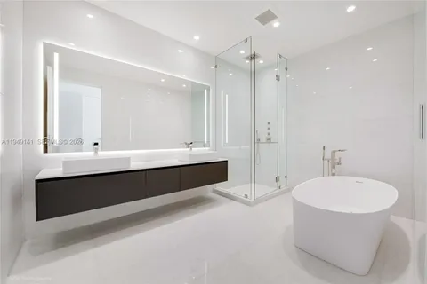 a bathroom with a granite countertop toilet a sink and bathtub