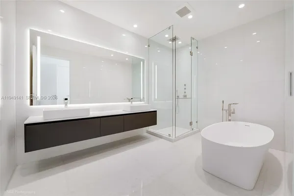 a bathroom with a granite countertop toilet a sink and bathtub